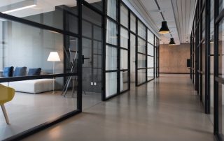 Commercial office cleaning in a modern glass-partitioned office designed for workplace health and cleanliness in 2026
