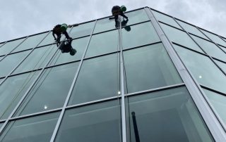 Rope access window cleaners working on a glass high-rise building in Kansas City
