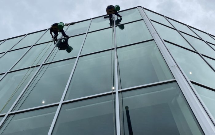 Rope access window cleaners working on a glass high-rise building in Kansas City