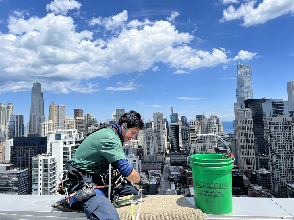 Ascent window washer checking their safety equipment before cleaning a Chicago high rise.