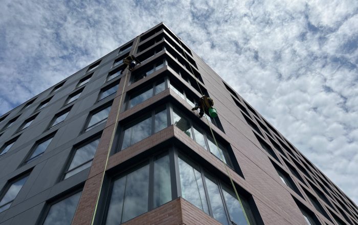 Window cleaners descending down a mid-rise office building in Chicago