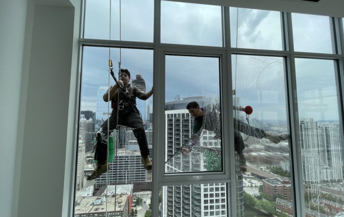 Window washers cleaning the exterior windows of a Chicago apartment building