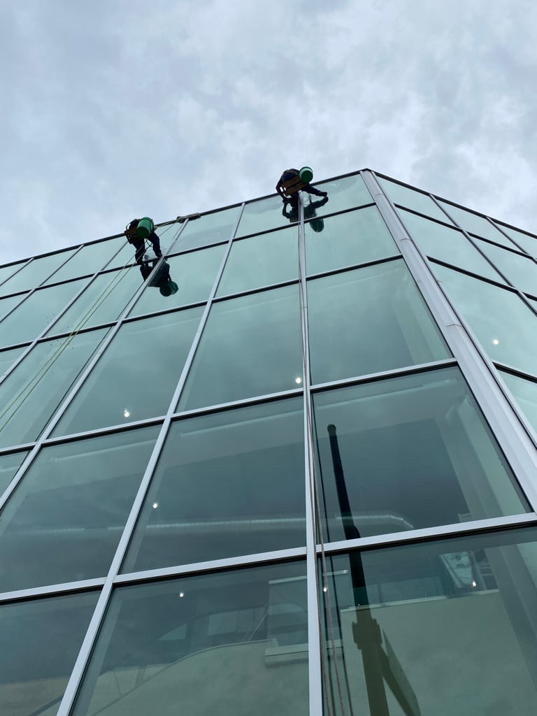 Two window cleaners descending down a Chicago building