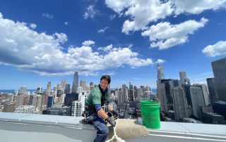 Window cleaner checking their safety equipment in Chicago