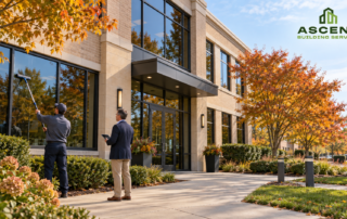 Commercial property maintenance in Downers Grove, IL, with a window cleaner and property manager outside an office building in fall.